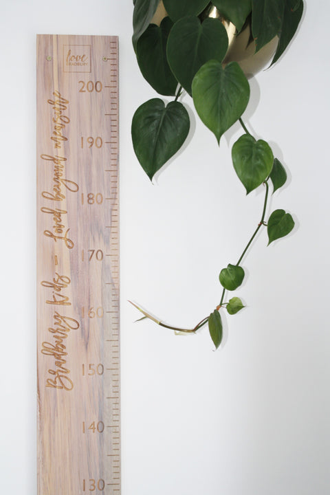 Madina Script font quote on whitewashed recycled rimu height chart